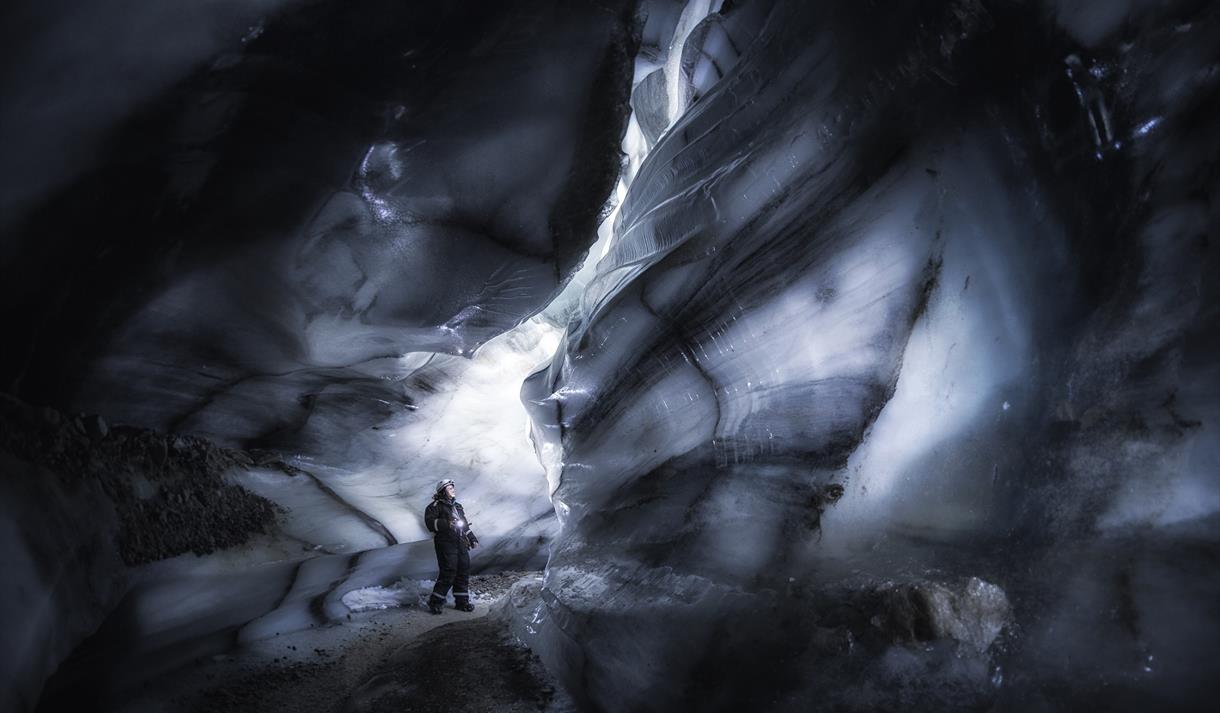 A guest looking around inside the ice cave