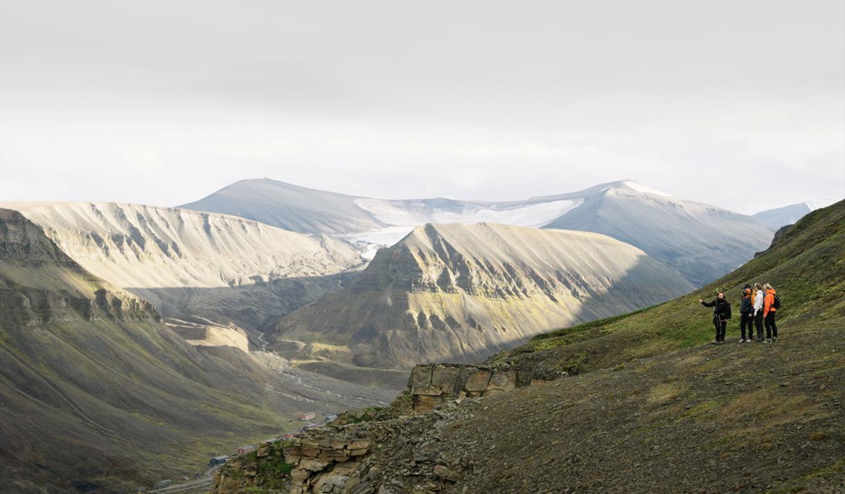 view from mountaintop, with several mountains in the background