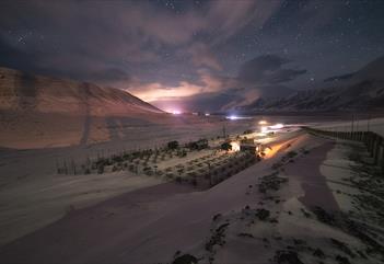 Commercial dogyard under a starry sky