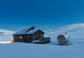 Juva Cabin underneath a blue sky