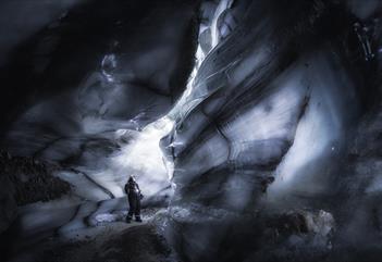 A guest looking around inside the ice cave