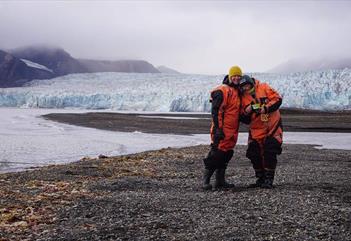 Two guests with a glacier in the background