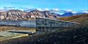 Picture taken from the backside of the seedvault on a sunny summerday. 
The seedvault and the Adventfjord is seen in the background.