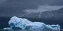 A big iceberg floating in a fjord