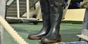 A pair of rubber boots on a ship's deck