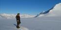 Guest enjoying the view on the glacier, during a snowmobiletrip