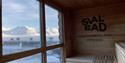 The view towards mountainous landscapes and a fjord from the interior of the sauna