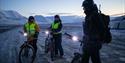 A guide and two guests on bikes taking a break during a trip