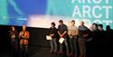 Persons standing in front of a cinema screen