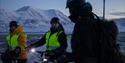 A guide and two guests on bikes taking a break during a trip