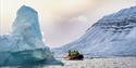 A RIB boat with guests sailing in between icebergs