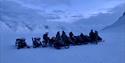 Tour-group with snowmobiles