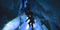 Persons inside the ice cave with headlamps on