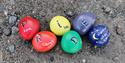 Stones decorated with pride colours and messages