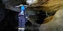 A child looking at ice formations inside the ice cave