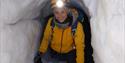 A person inside an ice cave