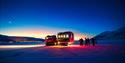 A group of guests walking around a snowcat