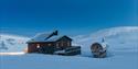 Juva Cabin underneath a blue sky