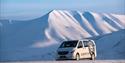 A car driving through a snowy landscape