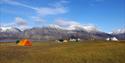 Tents on a camping site with mountains in the background