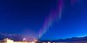 Faint northern lights shining above Camp Barentz