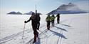 Four persons skiing