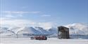 People standing beside a snowcat