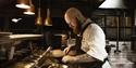 A cook preparing food