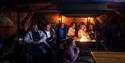 Guests listening to a lecture inside the cabin at Camp Barentz