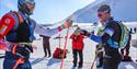 Two participants congratulating each other after reaching the finish line at Svalbard Skimaraton