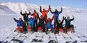 A tour group posing for the camera on their sleds