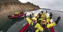 Guests enjoying themselves on board RIB boats sailing through a fjord