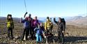 Several persons cheering and looking happy during a hike