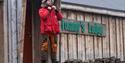 A person standing on some stairs in front of Tommy's Lodge