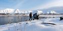 several people hiking up the snowcovered mountain