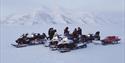 Guests taking a break during a snowmobiletrip