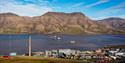 view from the mountain, over the fjord and mountains in the background