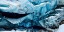 several people standing in front of a glacier