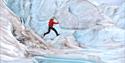 Person jumping on a glacier