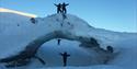 Persons exploring an ice formation