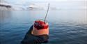 Dessert served in a glass shown in front of the sea