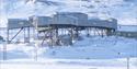 The building known as the cableway central in Longyearbyen in bright snowy surroundings