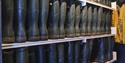 Rubber boots organised in rows on shelves