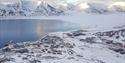 Longyearbyen and nearby snow-covered mountains seen from Platåfjellet