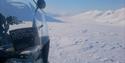 Snowmobile in the front. snowcovered landscape seen in the background