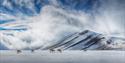 A herd of reindeer on top of a snowy plateau