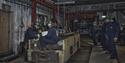 Guests on a guided tour of Mine 3 being shown around the mechanical workshop in the mine