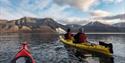 Kayaks in front of Hiorthfjellet, which is in the background.