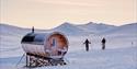 Two skiers next to the sauna at Juva Cabin