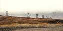 Cableway towers in a line situated on top of a hill outside of Longyearbyen